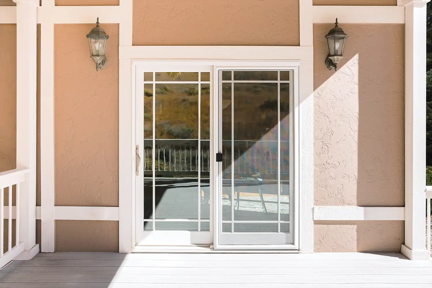 Exterior view of a white Marvin Replacement sliding French door with prairie grilles.