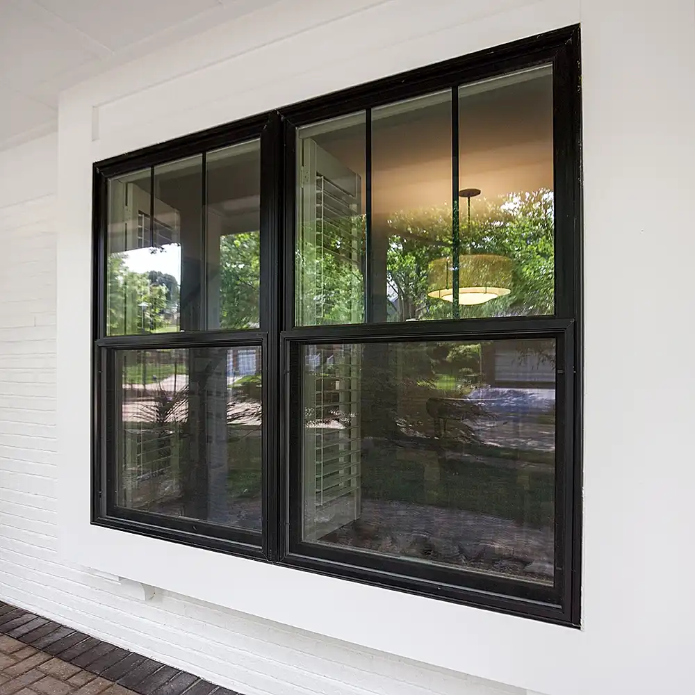 Exterior view of black Marvin Replacement single hung windows with prairie grilles.