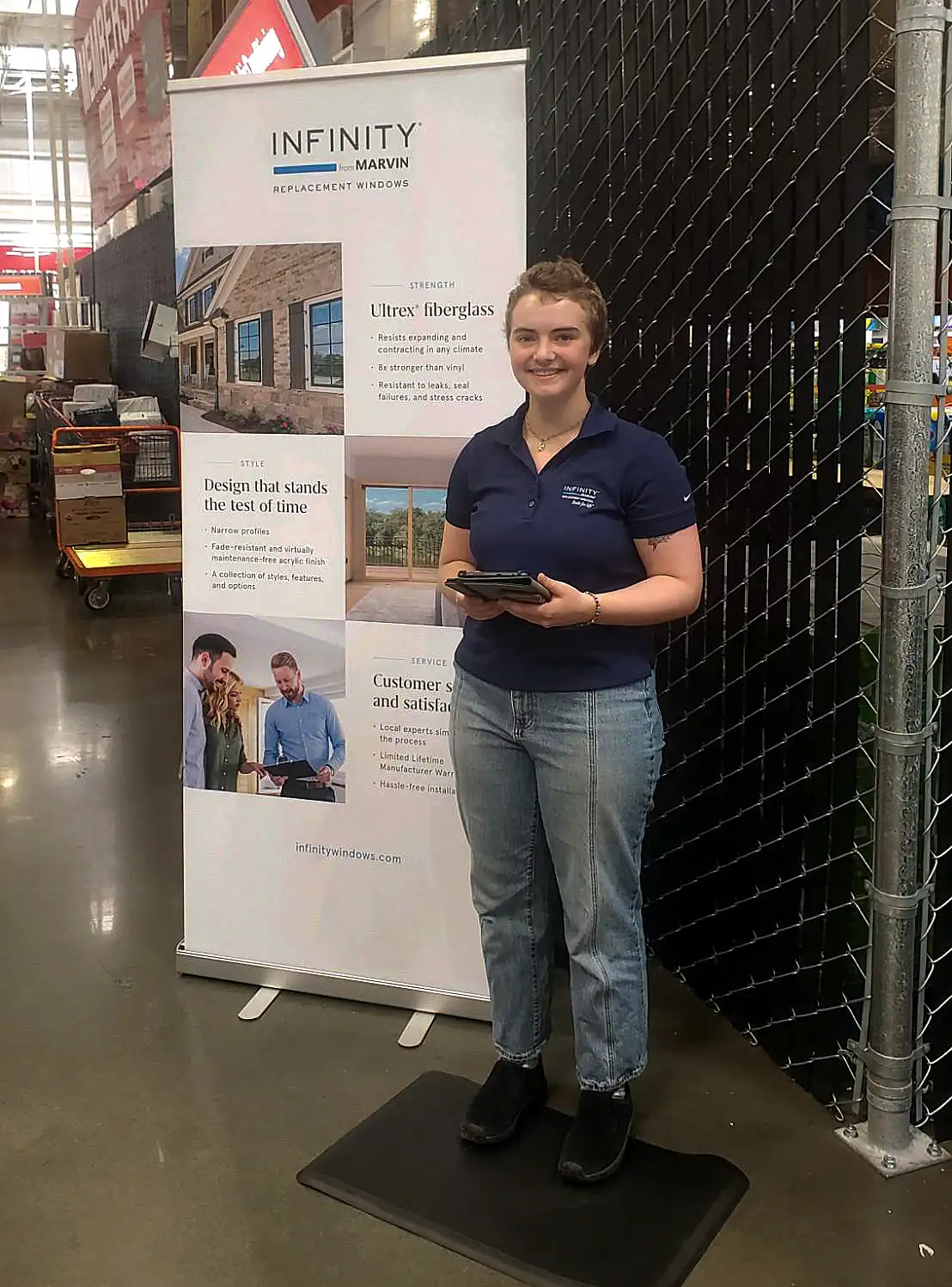 An Infinity from Marvin brand ambassador stands next to a display in a Costco.