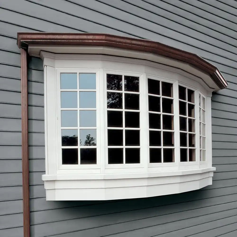 Exterior view of a five-wide white Marvin Replacement casement bow window.