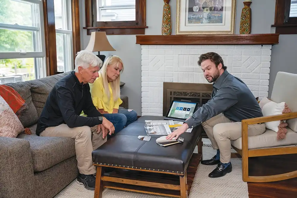 A middle aged couple meets with Marvin Replacement design consultant.