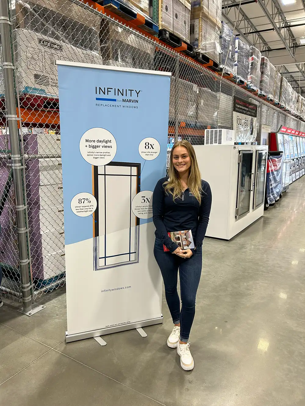 An Infinity from Marvin brand ambassador stands next to a display inside a Costco.