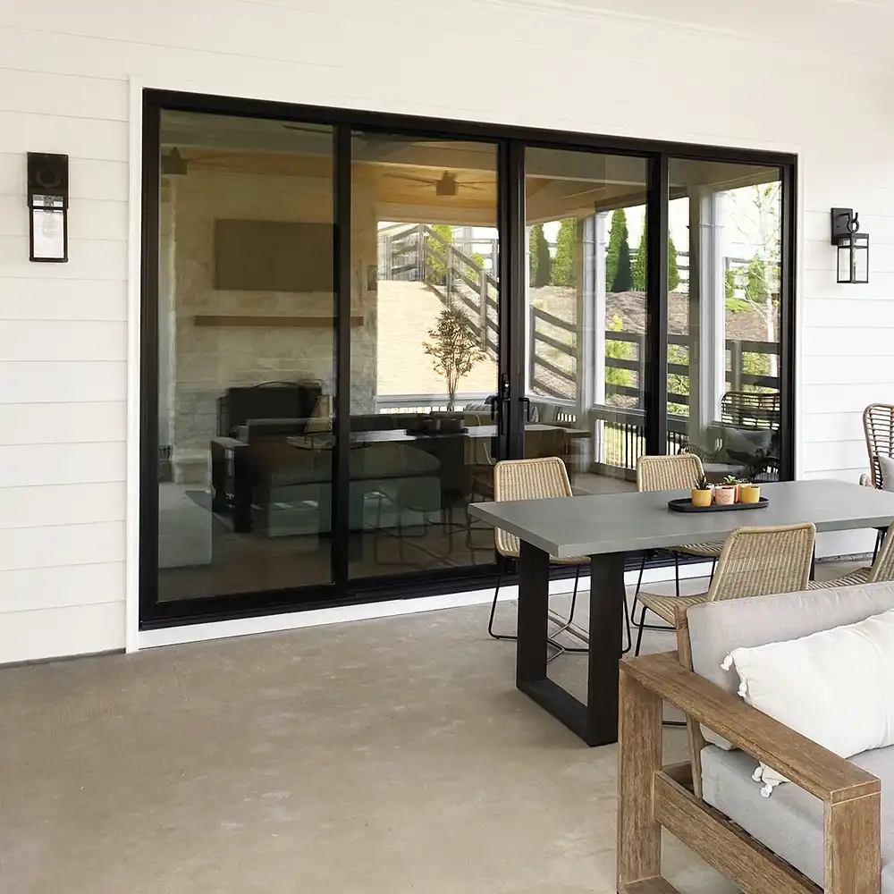 Exterior view of a black four-panel Marvin Replacement sliding patio door.