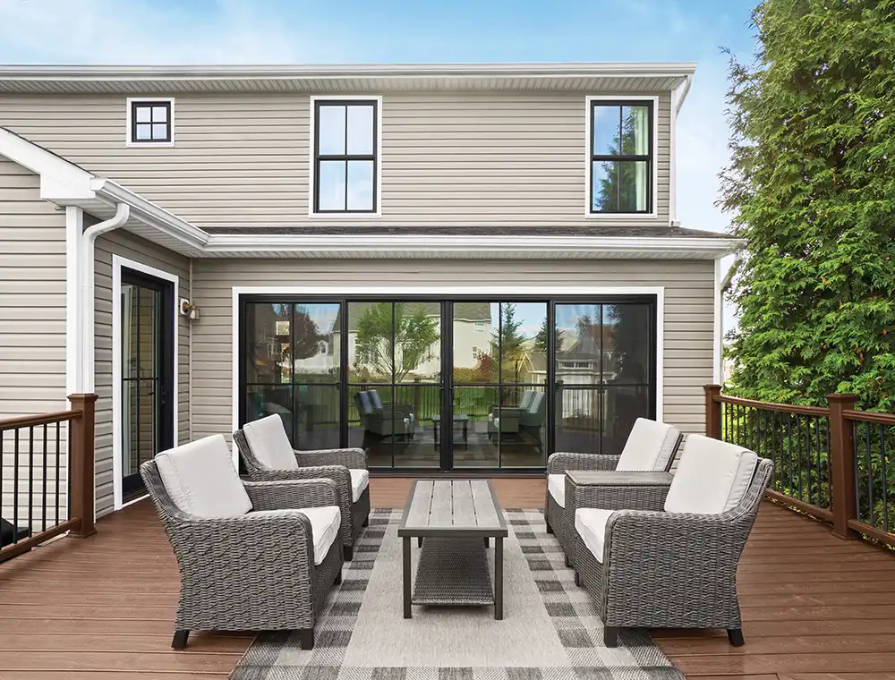 Patio exterior with a black four-panel Marvin Replacement Sliding Patio door with grilles.