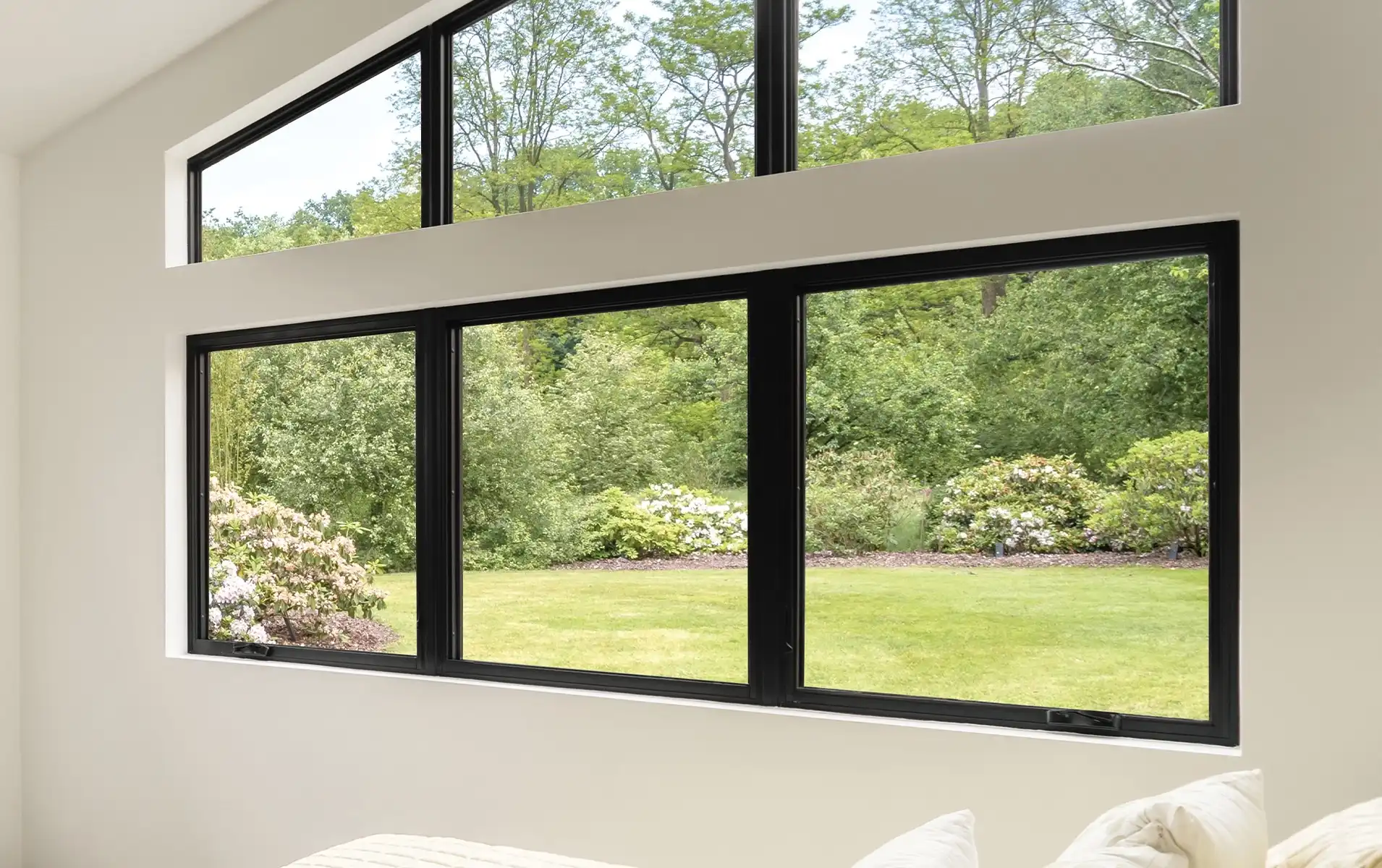 Interior view of a white living room with black special shape Marvin Replacement windows.
