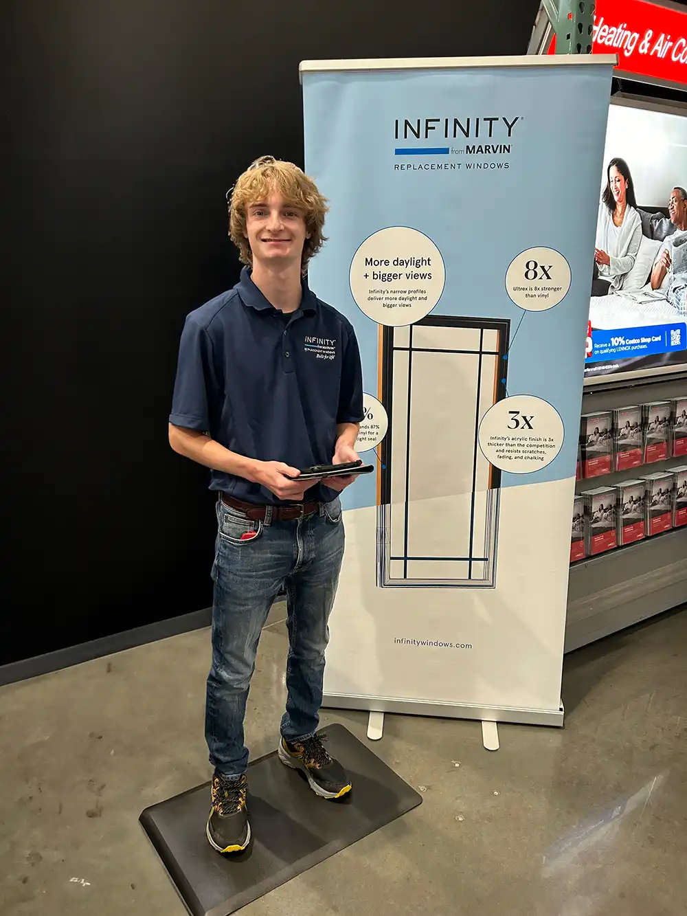 An Infinity from Marvin brand ambassador stands next to a display inside a Costco.